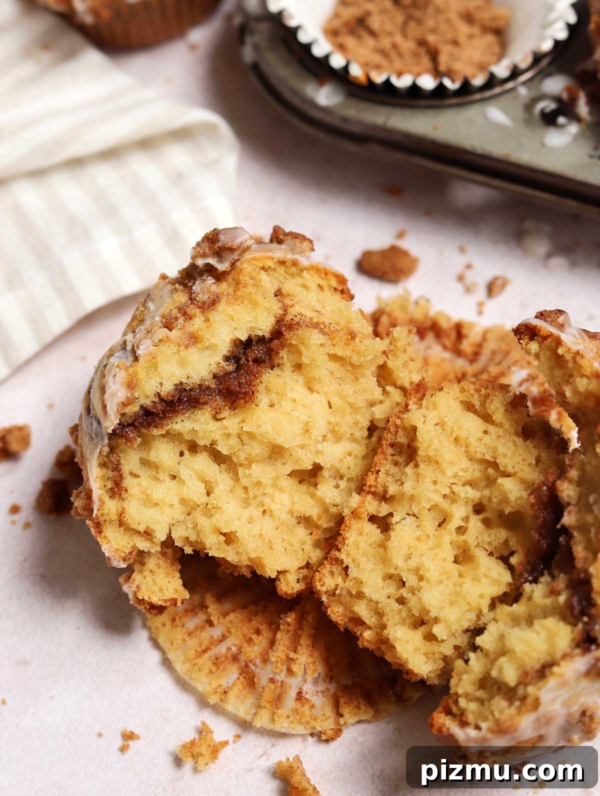 Sour Cream Coffee Cake Muffins Recipe with Cinnamon Streusel 5 sour cream coffee cake muffin broken in half showing cinnamon filling through the middle