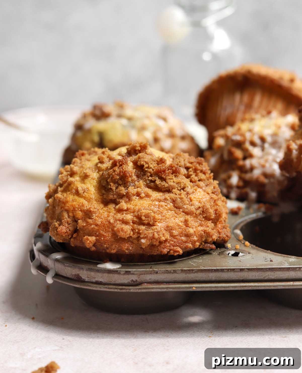 Sour Cream Coffee Cake Muffins Recipe with Cinnamon Streusel 10 sour cream coffee cake muffins in muffin pan showing tall muffin top