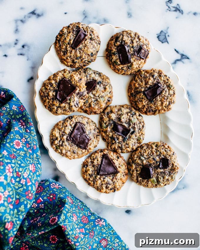 Seedy Currant Cookies with Mixed Seeds and Oats 4 Cookies cooling on a rack with visible currants and seeds