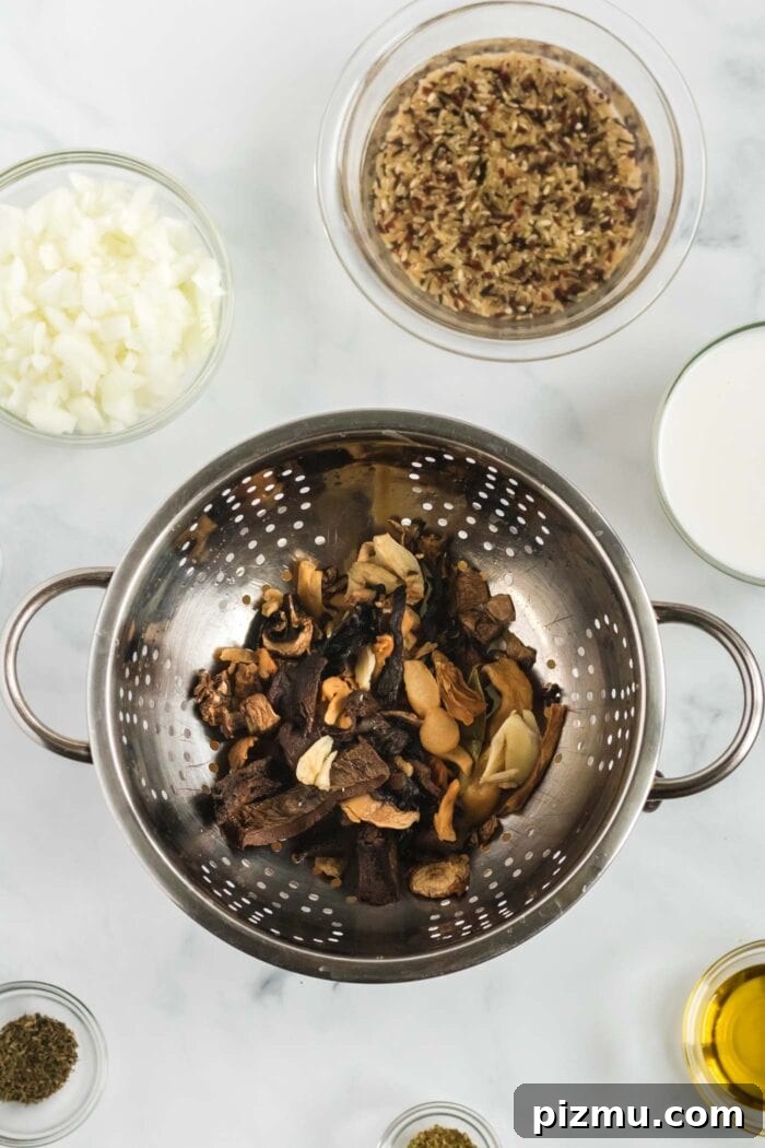 Creamy Vegan Mushroom and Wild Rice Soup 6 A variety of soaked pieces of dried mushrooms in a strainer.