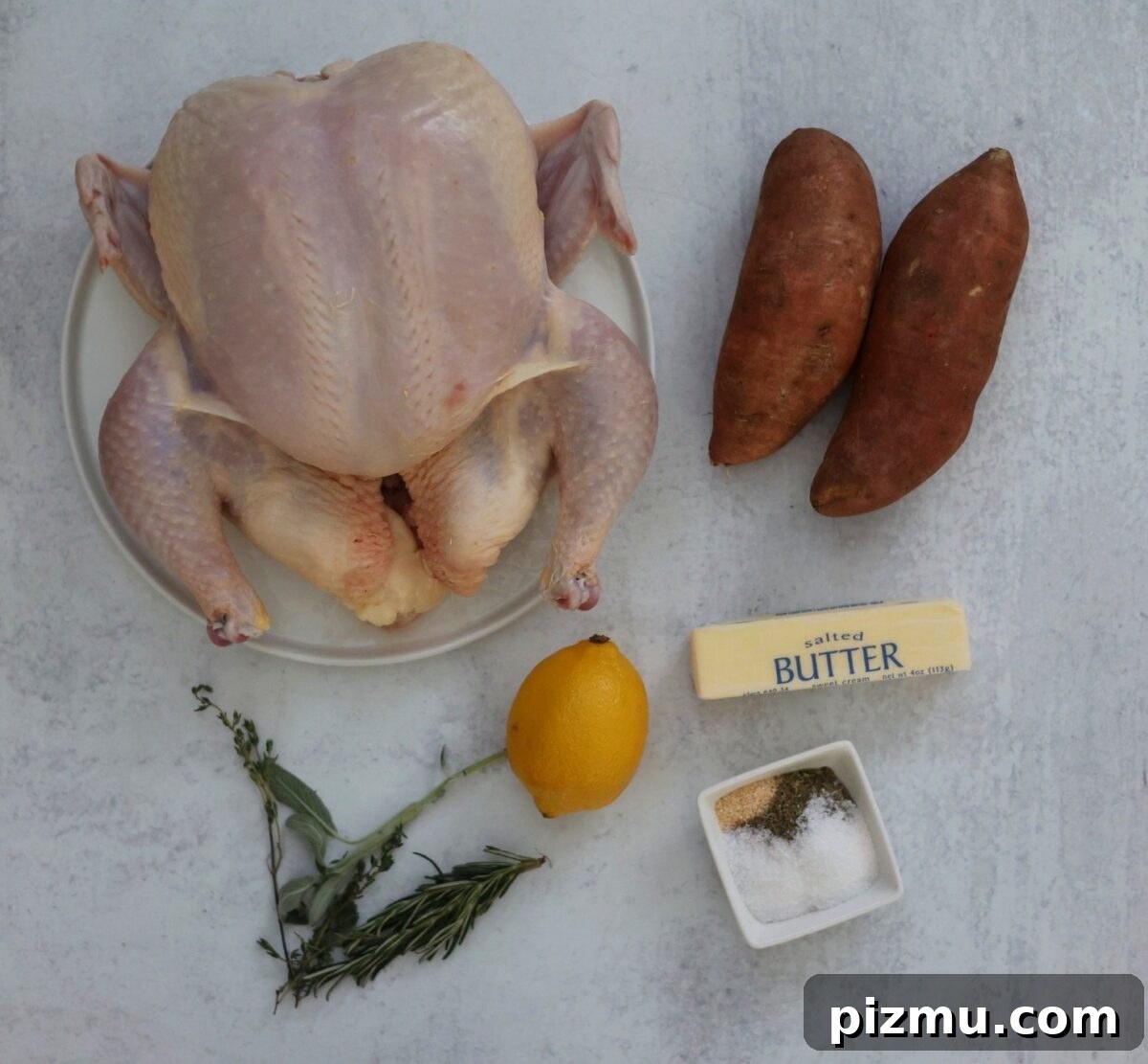 Whole chicken, sweet potatoes, spices, butter, lemon, and herbs.