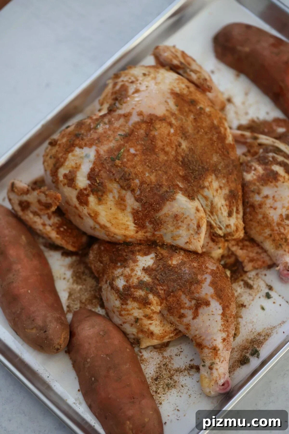 raw seasoned chicken and uncooked sweet potatoes.