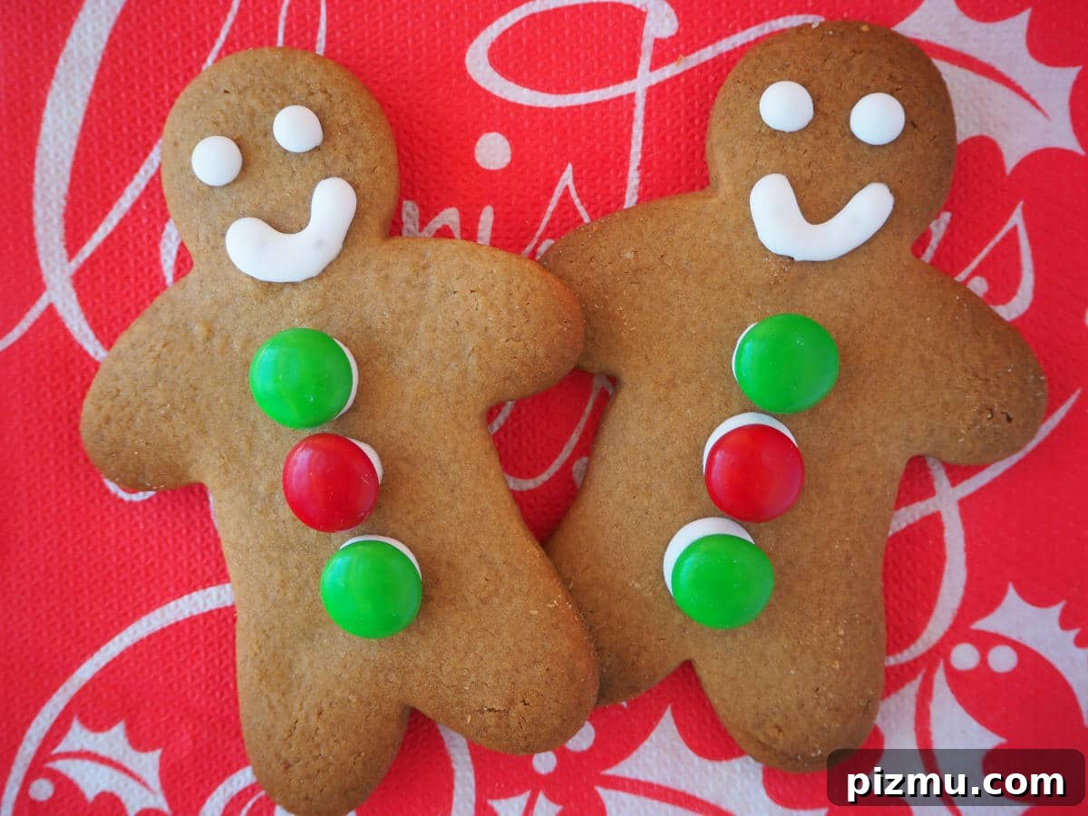 Pair of decorated gingerbread men on a red Christmas serviette