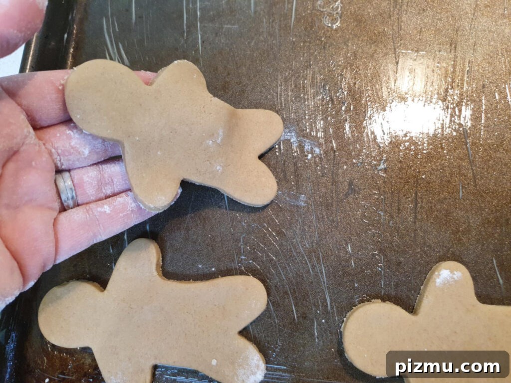 Laying out gingerbread men on baking trays
