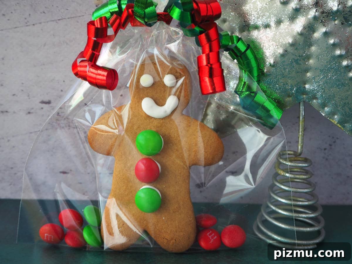 Gingerbread man wrapped as a gift in a clear bag with red and green M&Ms
