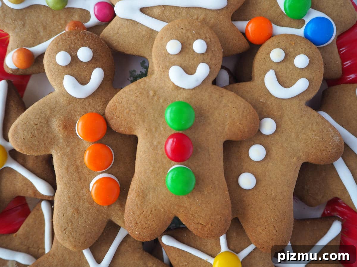 Close up of three gingerbread men surrounded by other decorated gingerbread