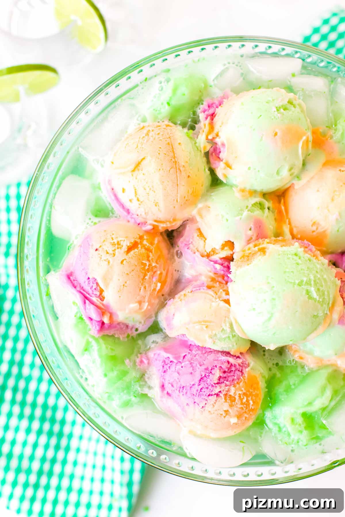Overhead photo of a bowl of punch topped with rainbow sherbet.