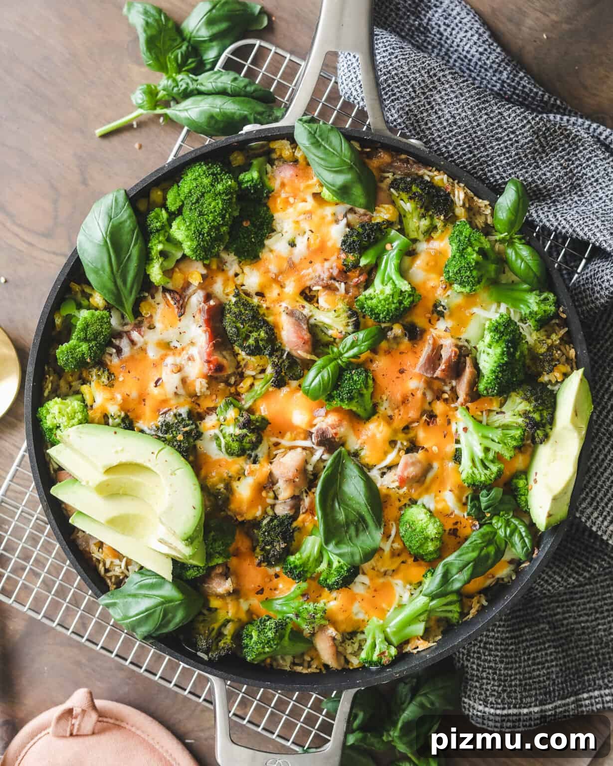 Cheesy Chicken, Broccoli and Rice Casserole 2 Easy Chicken Broccoli and Cheese Casserole on a cooling rack with a dish cloth
