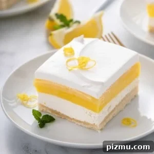 Creamy Layered Lemon Trifle Recipe 12 Close up image of a slice of layered lemon dessert on a white plate.