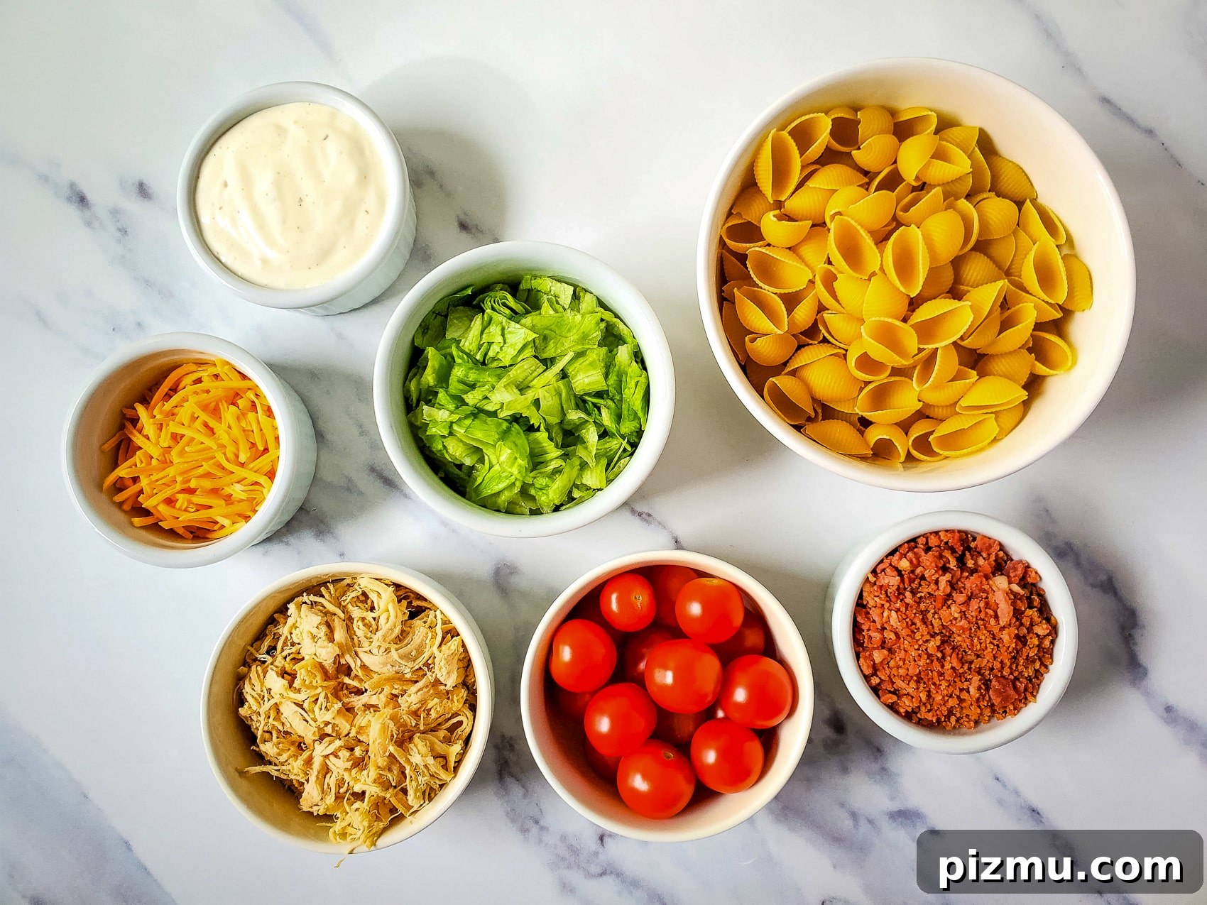 ingredients for chicken bacon ranch pasta salad in bowls