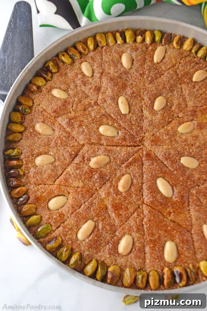 Basbousa: Classic Middle Eastern Semolina Cake with Syrup 3 A whole tray of Egyptian basboosa garnished with pistachios and almonds.