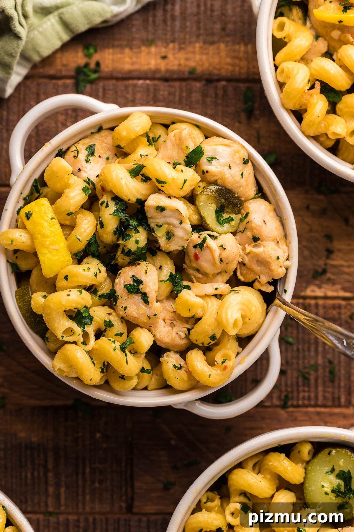 Creamy Lemon Chicken Pasta in the Instant Pot 10 A bowl of Pasta with Zucchini and Squash, tender chicken, and fresh herbs sits on a wooden table—an easy instant pot pasta dinner for any night.