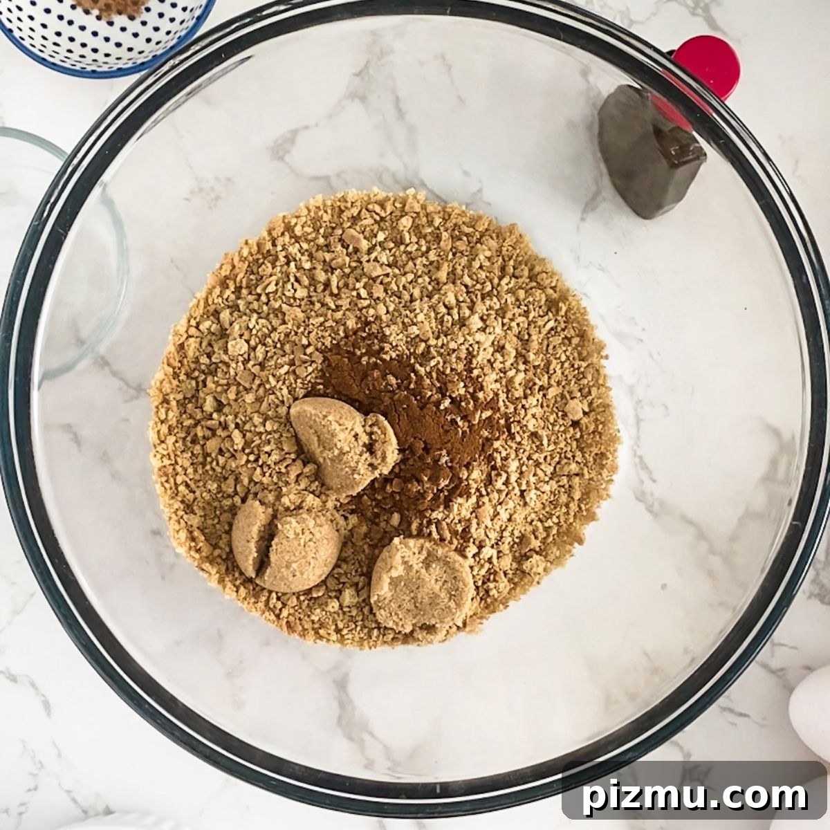 Paula Deen's Classic Pumpkin Cheesecake Recipe 4 graham crackers, cinnamon and brown sugar in a bowl.
