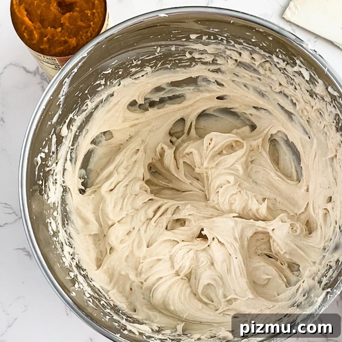 Paula Deen's Classic Pumpkin Cheesecake Recipe 7 beaten cream cheese in a bowl.