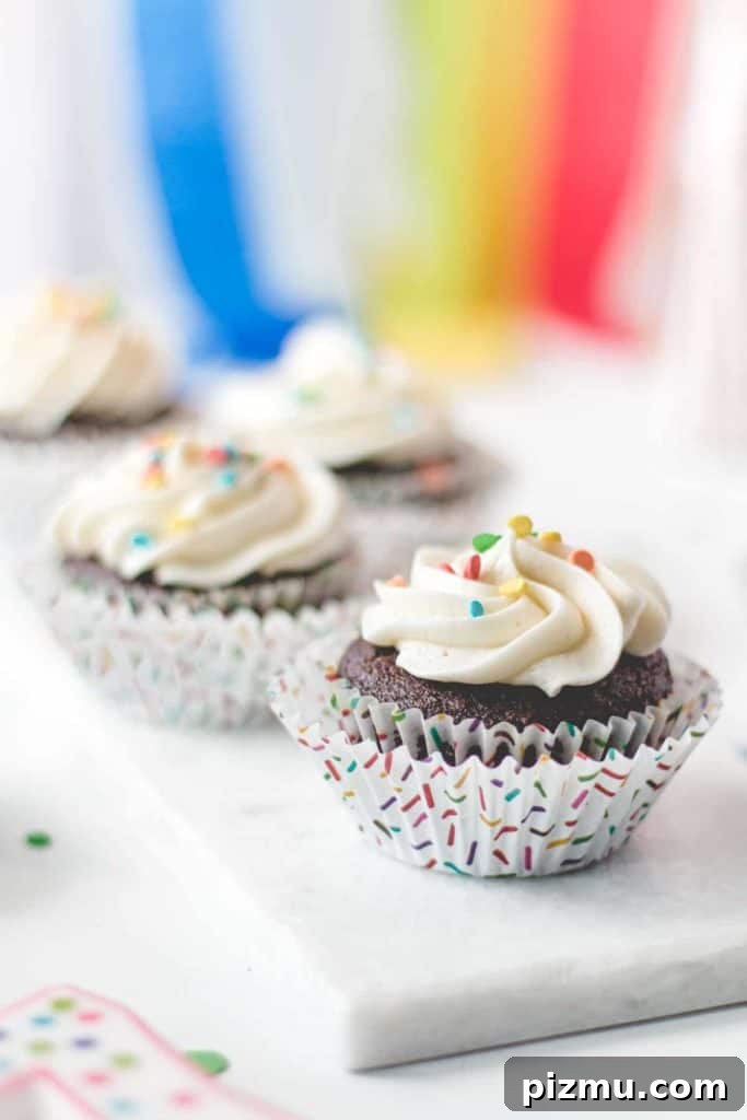 Celiac Disease: Lessons From My First Two Years 2 Gluten-free chocolate cupcakes with vanilla frosting and rainbow sprinkles. Rainbow streamers in the background.