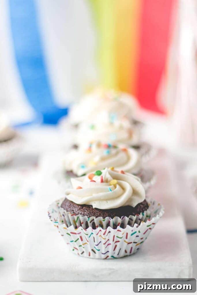 Celiac Disease: Lessons From My First Two Years 4 Gluten-free chocolate cupcakes with vanilla frosting and rainbow sprinkles in rainbow sprinkle cupcake wrappers.