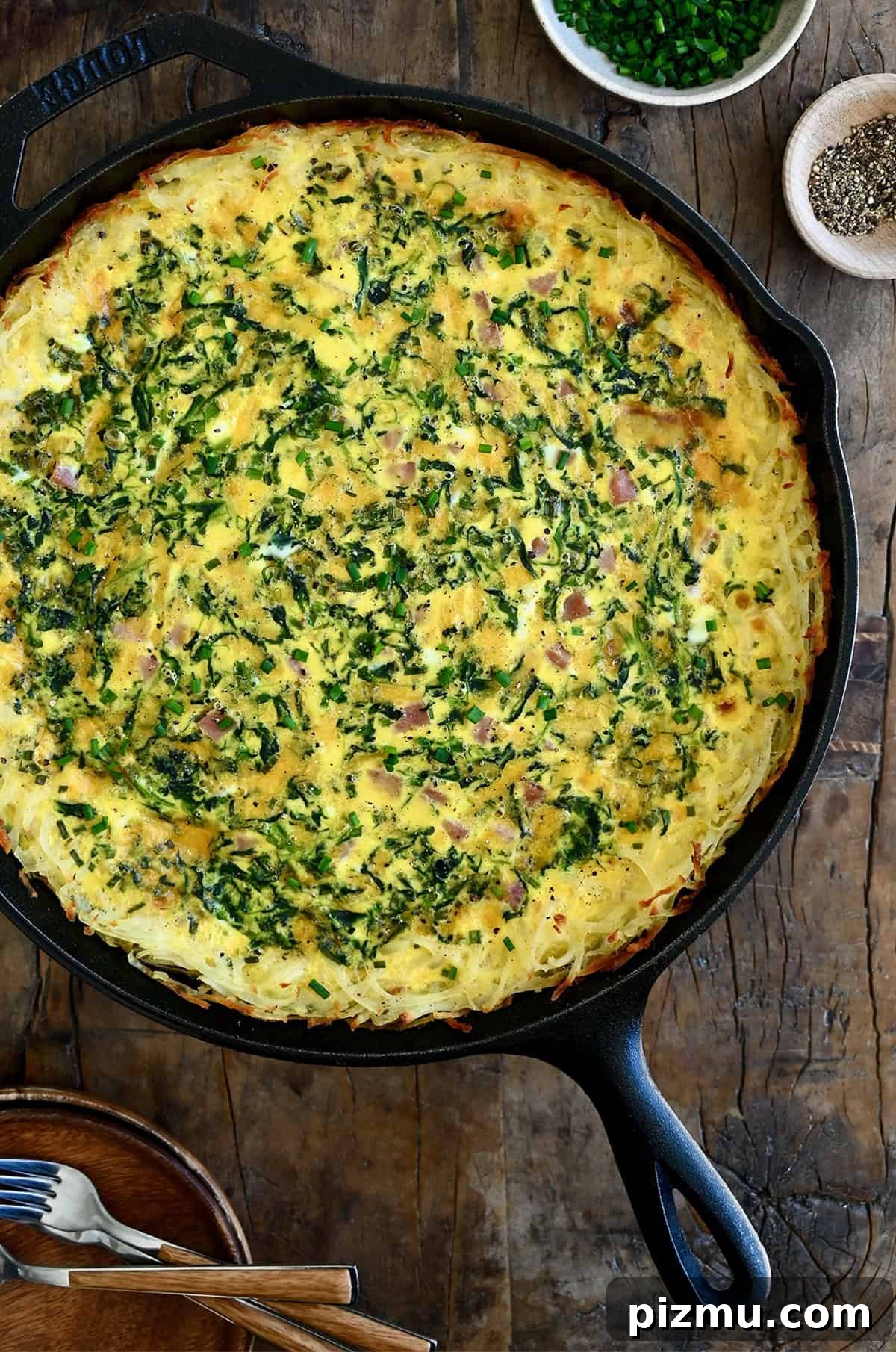 Ham and Cheese Quiche with Crispy Hash Brown Crust 10 Golden brown quiche with a crispy hash brown crust in a cast iron skillet.