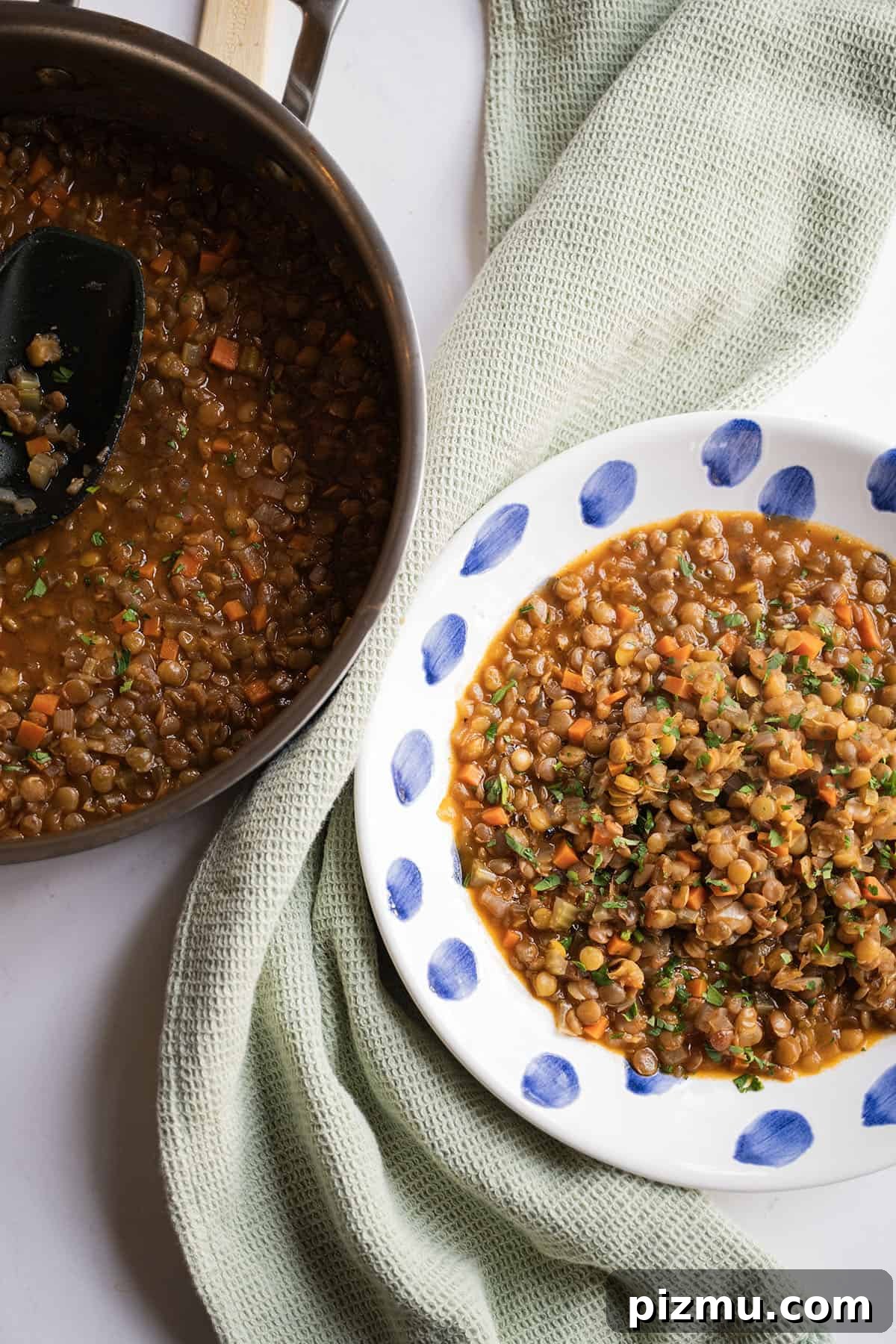Classic Italian Lentils with Garlic and Rosemary 9 Cooked lentils in a bowl next to saucepan of lentils.