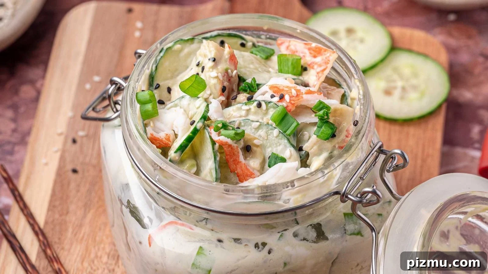 California roll cucumber salad with crab, avocado, and sesame seeds tossed together.