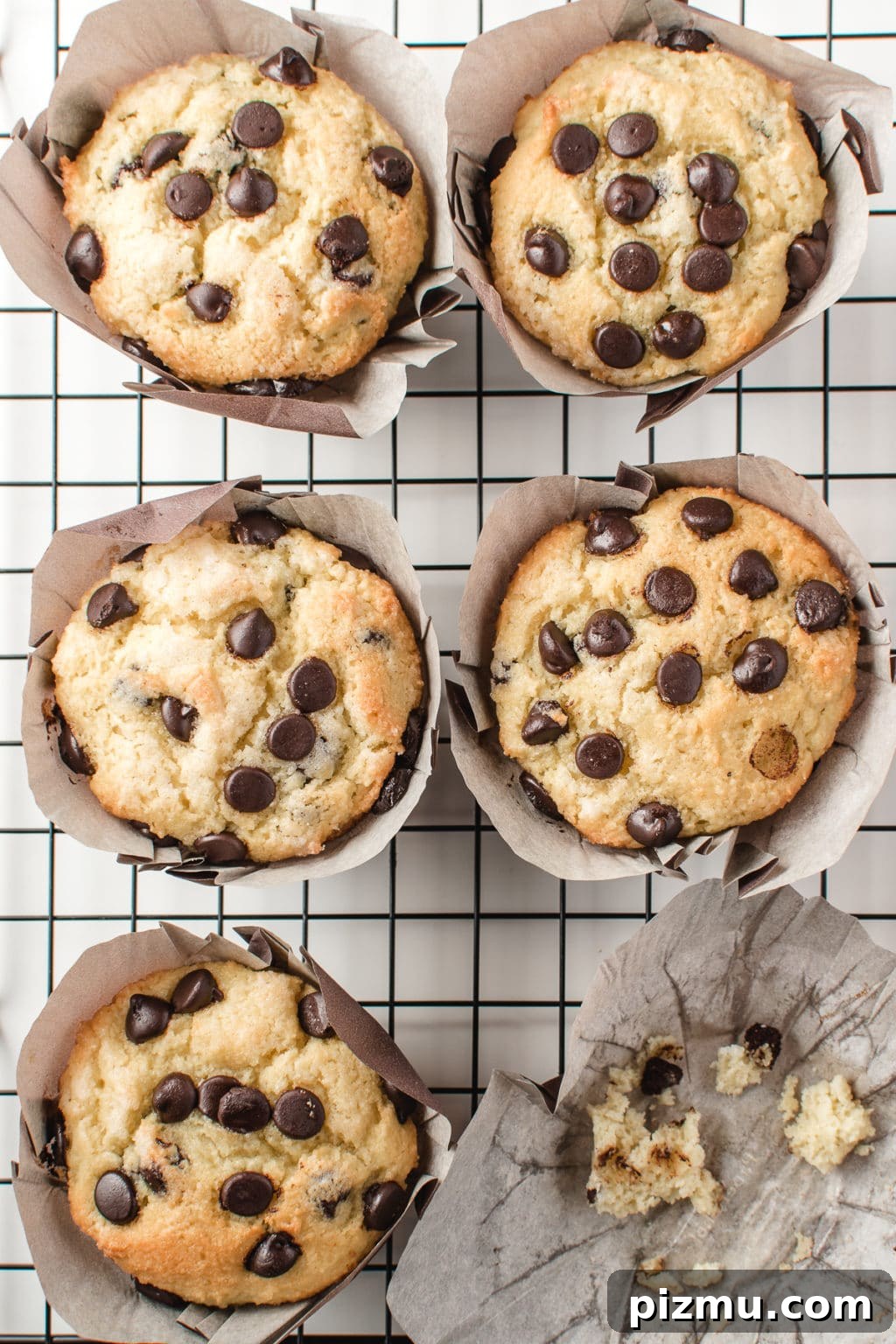 11 Keto Muffins for Quick Grab-and-Go Mornings 9 Bakery-style low-carb chocolate chip muffins resting on a cooling grid. The image is intended to show a keto-friendly, gluten-free breakfast option for chocolate lovers