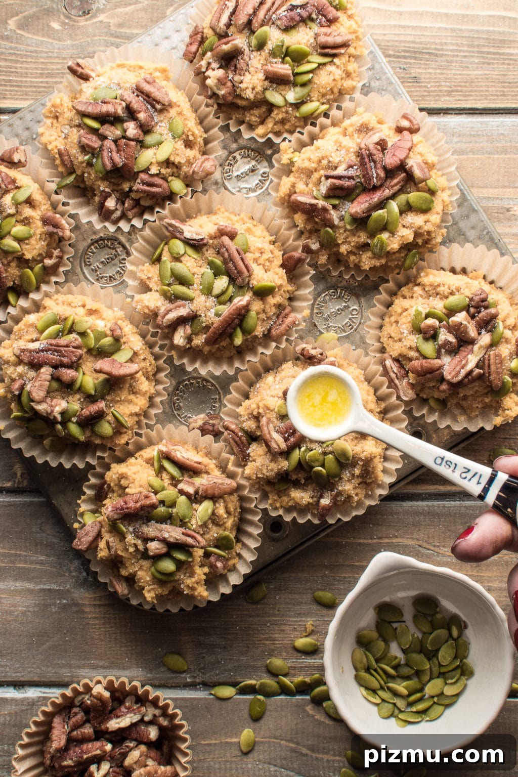 11 Keto Muffins for Quick Grab-and-Go Mornings 13 Low-carb pumpkin spice muffins topped with pecans and pumpkin seeds. The image intended to show an example of keto muffin recipes you can make on a carb restricted diet.