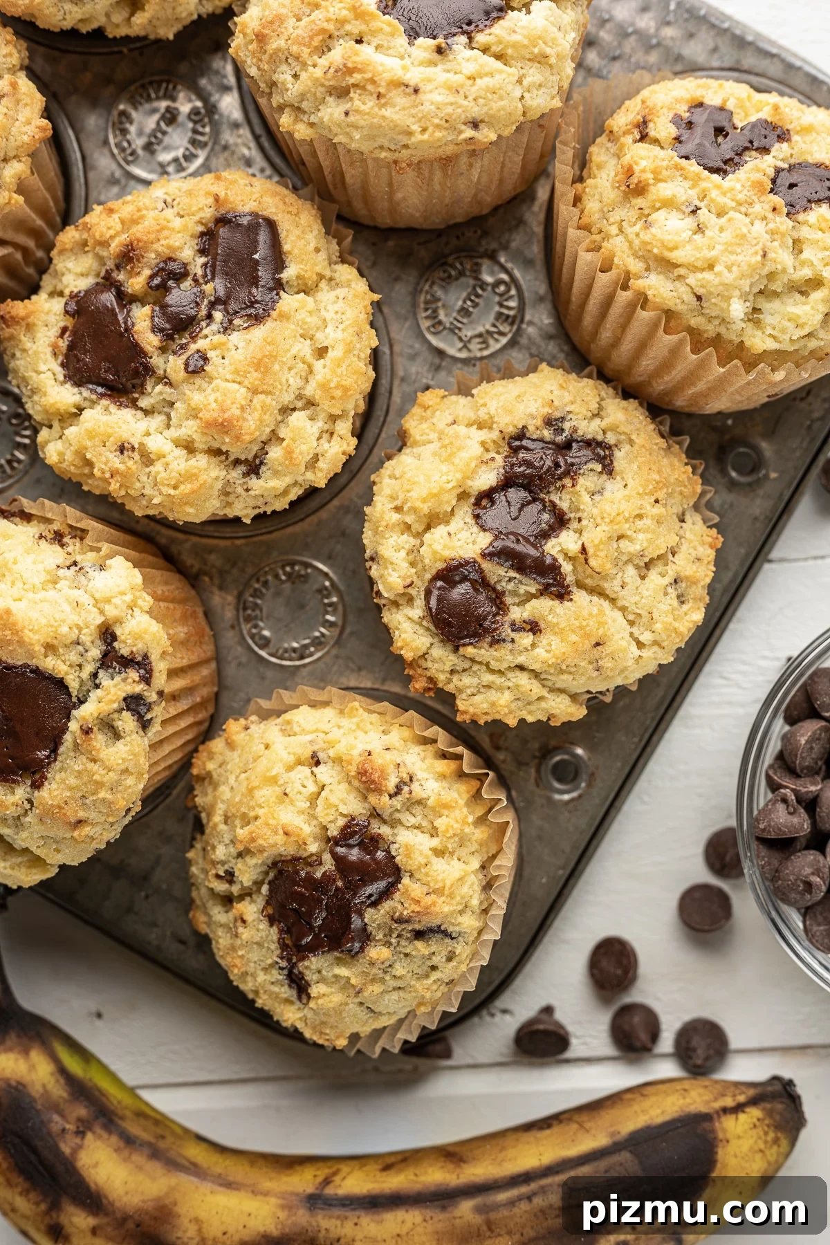 11 Keto Muffins for Quick Grab-and-Go Mornings 4 Low-carb banana muffins with chocolate chunks, a keto-friendly and gluten-free breakfast recipe with nostalgic flavors. The image intended to show an example of keto muffin recipes you can make on a carb restricted diet.