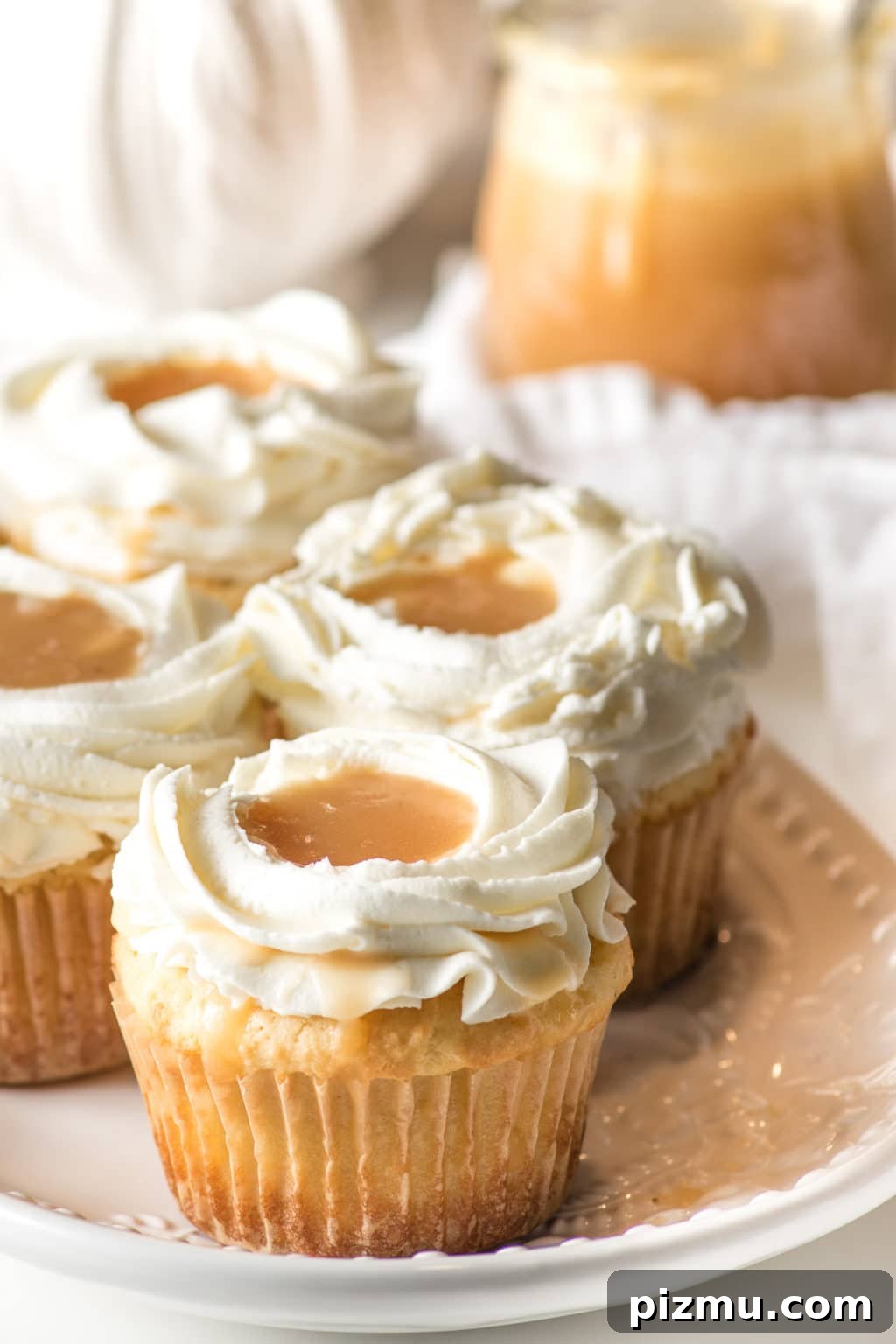 11 Keto Muffins for Quick Grab-and-Go Mornings 6 Closeup of keto salted caramel cupcakes, with a pool of caramel nestled in the frosting.