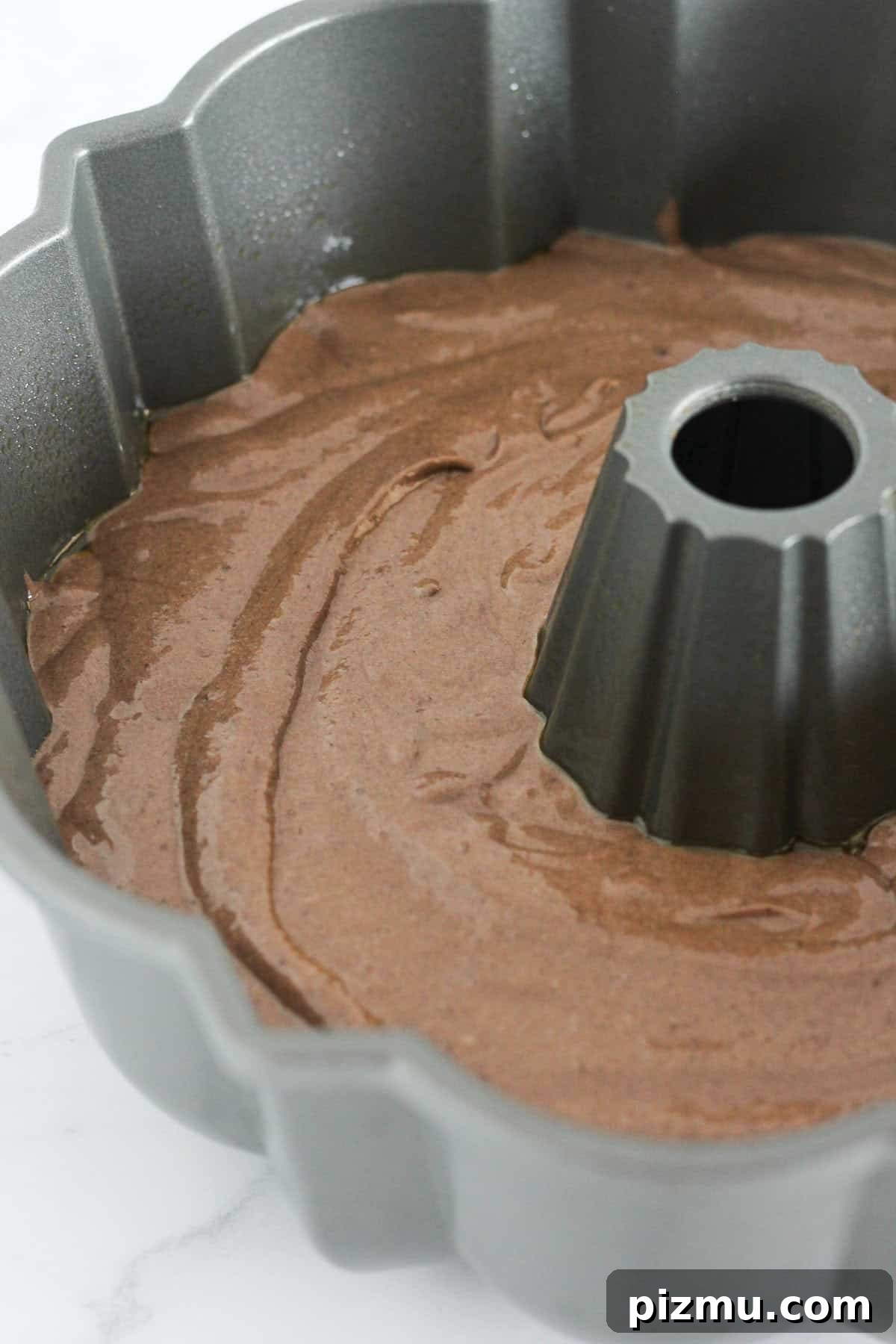 Moist Texas Sheet Cake Bundt: Chocolate Bundt Cake Recipe 5 Adding the chocolate cake batter to the bundt pan.