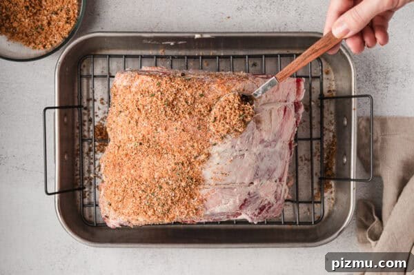Bone-In Prime Rib Roast 6 A spoon sprinkling seasoning rub over a prime rib roast.
