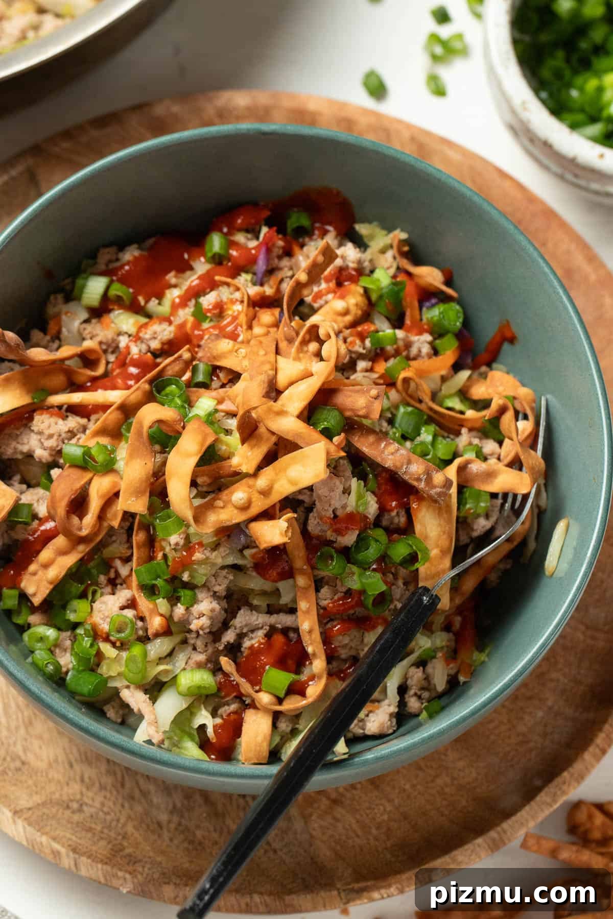 Ground Turkey Egg Roll Bowl with Soy-Ginger Sauce 11 Ground turkey, crisp egg roll chips, green onion and sriracha all mixed together in a bowl.