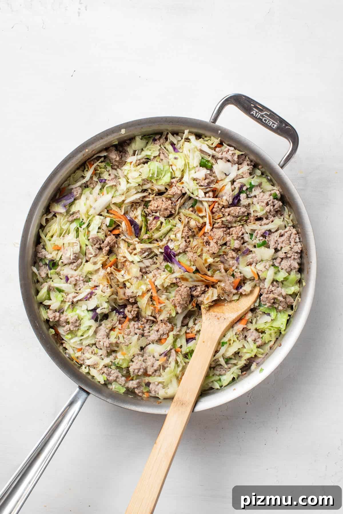 Ground Turkey Egg Roll Bowl with Soy-Ginger Sauce 7 Stirring the coconut aminos into the turkey and slaw mixture.