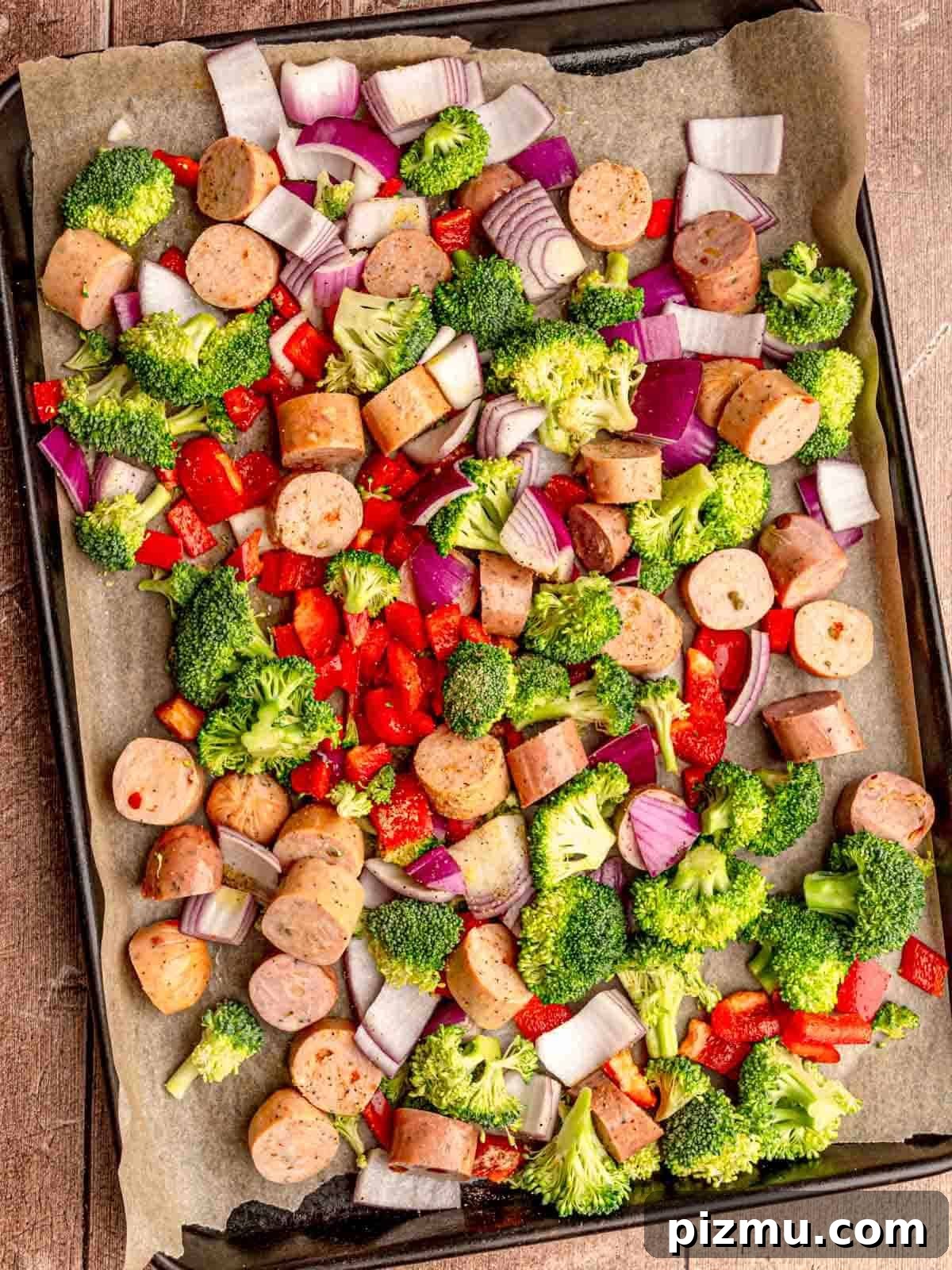 Sheet Pan Italian Sausage with Peppers and Broccoli Recipe 4 Vegetables and chicken sausage on a pan.