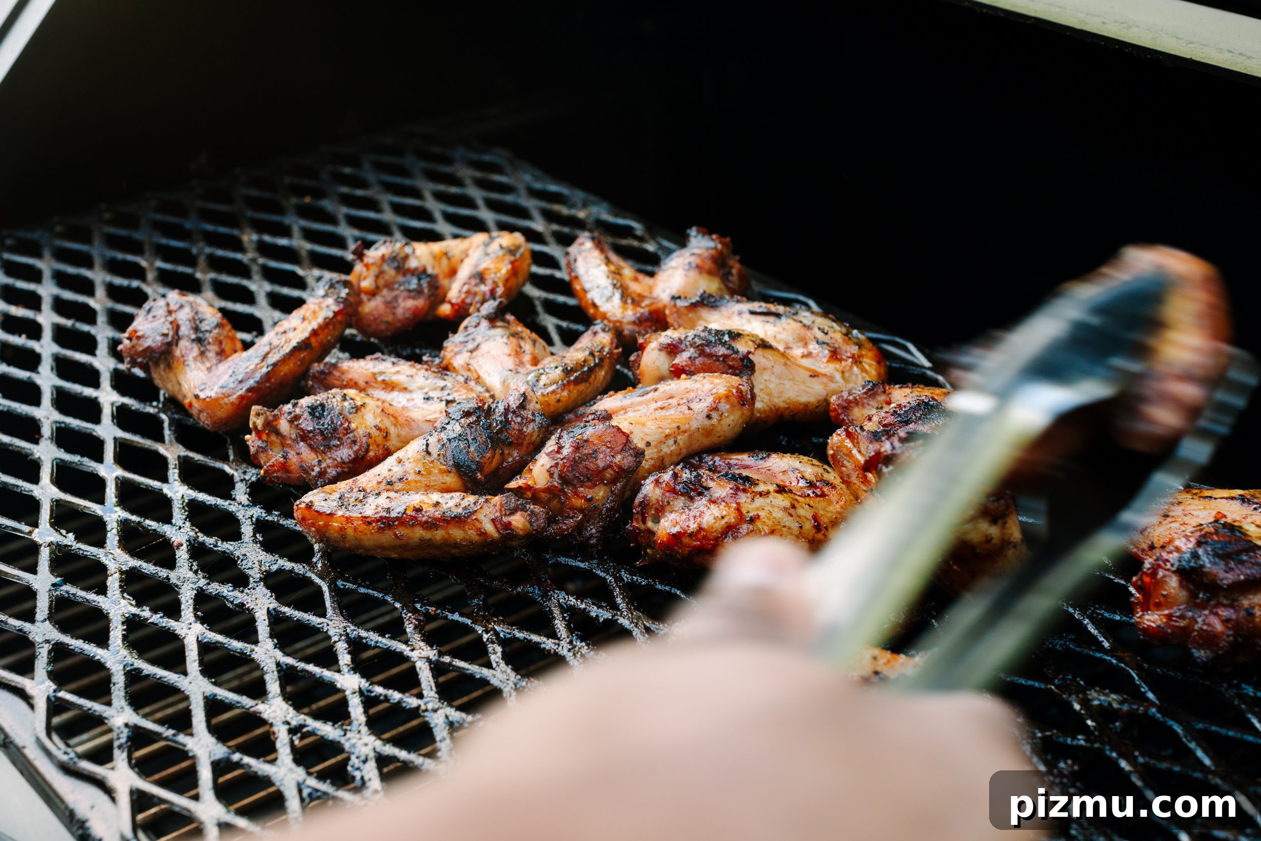 Buffaque Wings Recipe: Buffalo BBQ Chicken Wings 12 Smoked wings on a grill ready to be sauced.