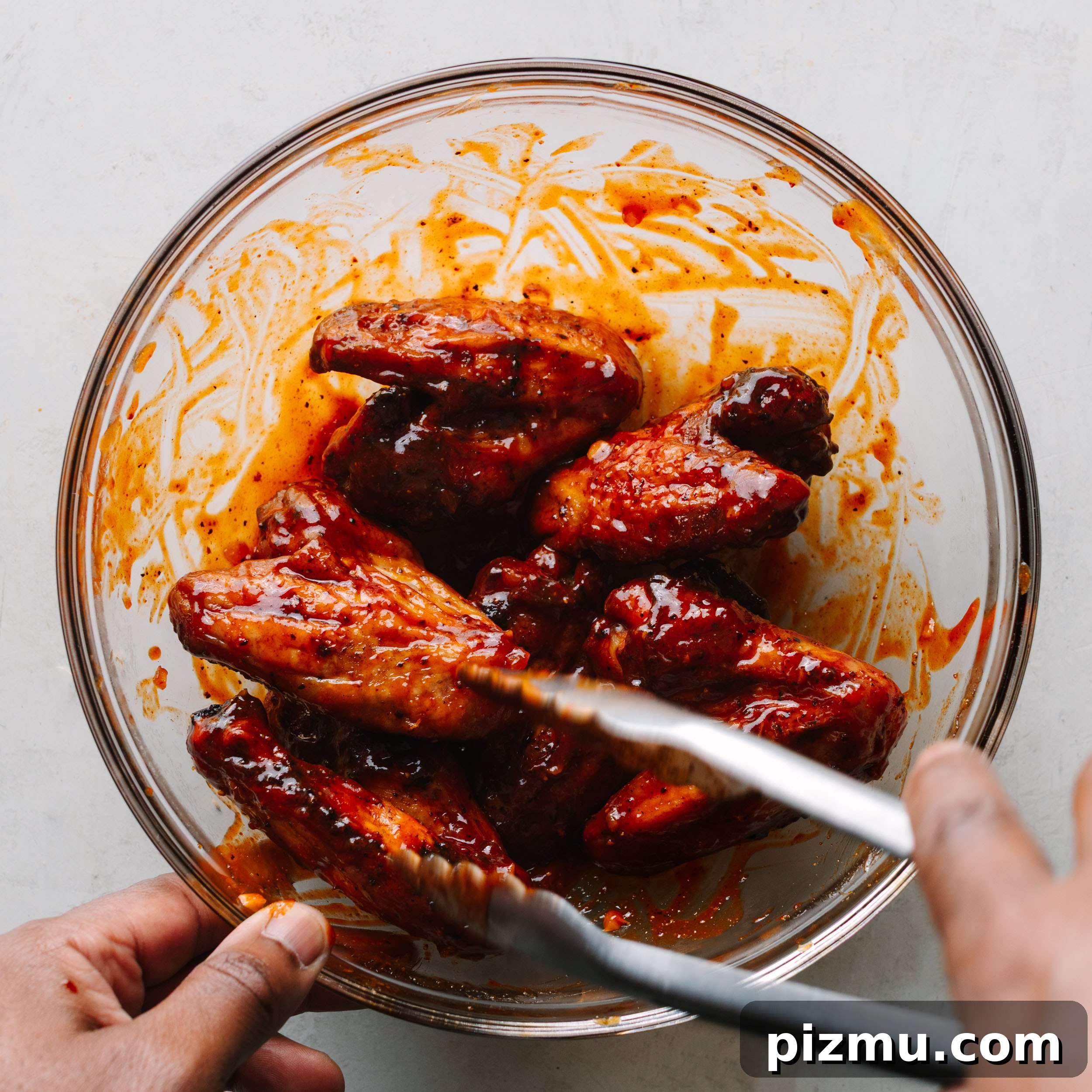 Buffaque Wings Recipe: Buffalo BBQ Chicken Wings 13 Tossing smoked wings in sauce.