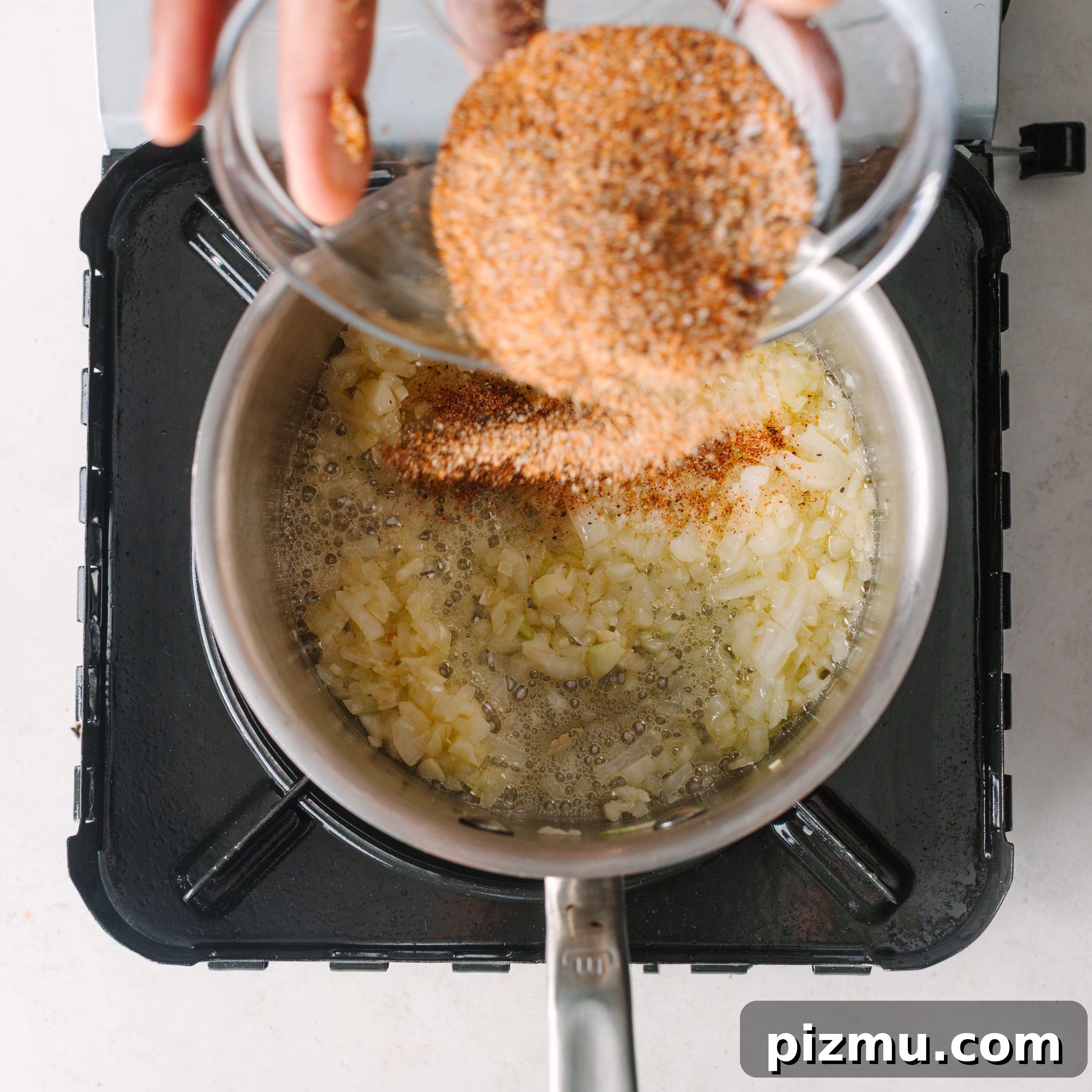 Buffaque Wings Recipe: Buffalo BBQ Chicken Wings 9 Mixing seasonings into the sauce.